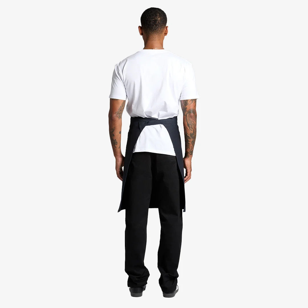 Man wearing AS Colour Carrie Half Apron Back in Navy - 1083