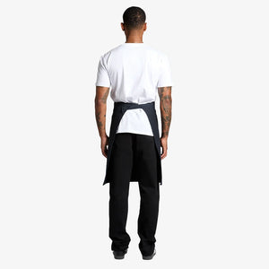 Man wearing AS Colour Carrie Half Apron Back in Navy - 1083