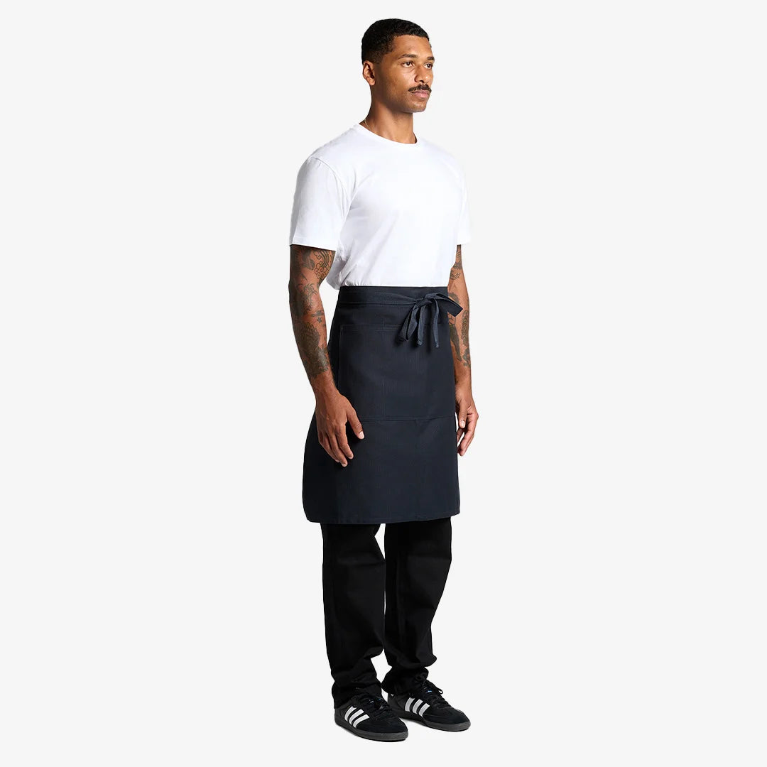 Man wearing AS Colour Carrie Half Apron Side in Navy - 1083