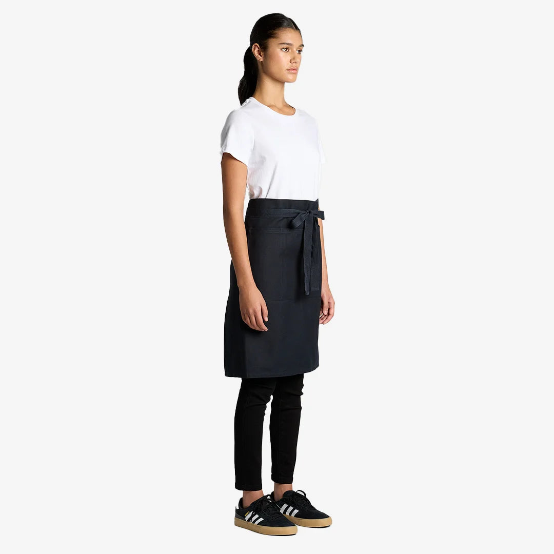 Woman wearing AS Colour Carrie Half Apron Side in Navy - 1083