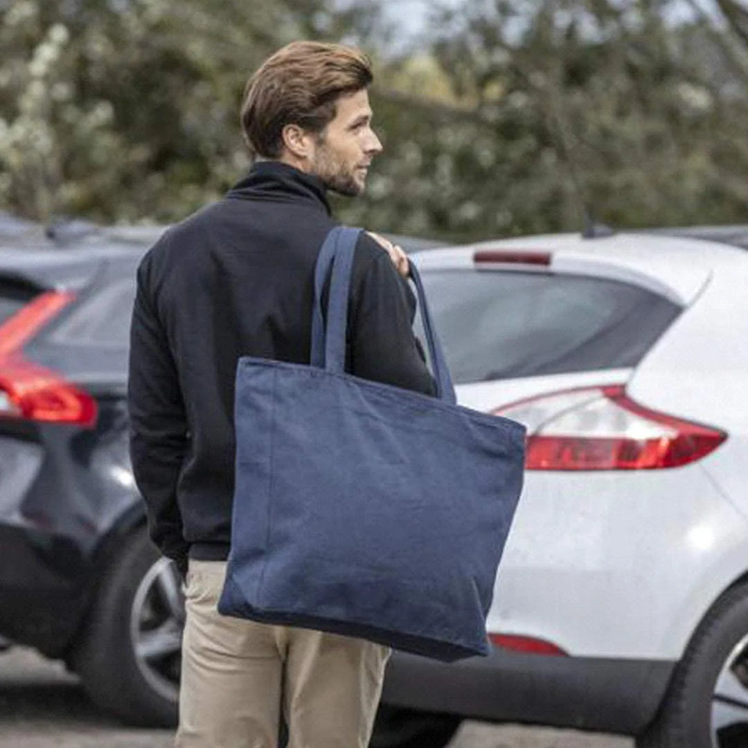 Man holding Darani Weekender Recycled Zip Tote in Navy - DA1014