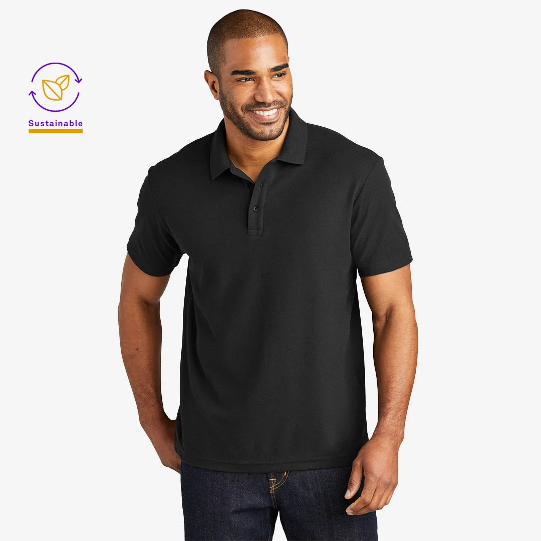 Man wearing Port Authority Men's C-FREE Cotton Blend Pique Polo Shirt in Black - K867