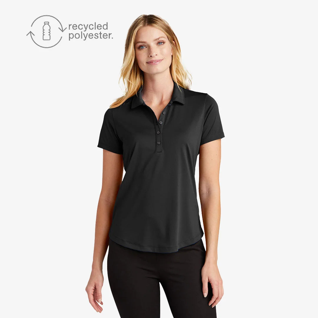 Woman wearing Port Authority Men's C-FREE Snag-Proof Polo Shirt in Deep Black - LK864