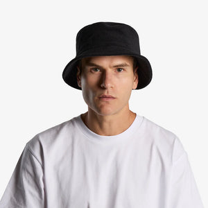Man wearing AS Colour Terry Bucket Hat Front in Black - 1175