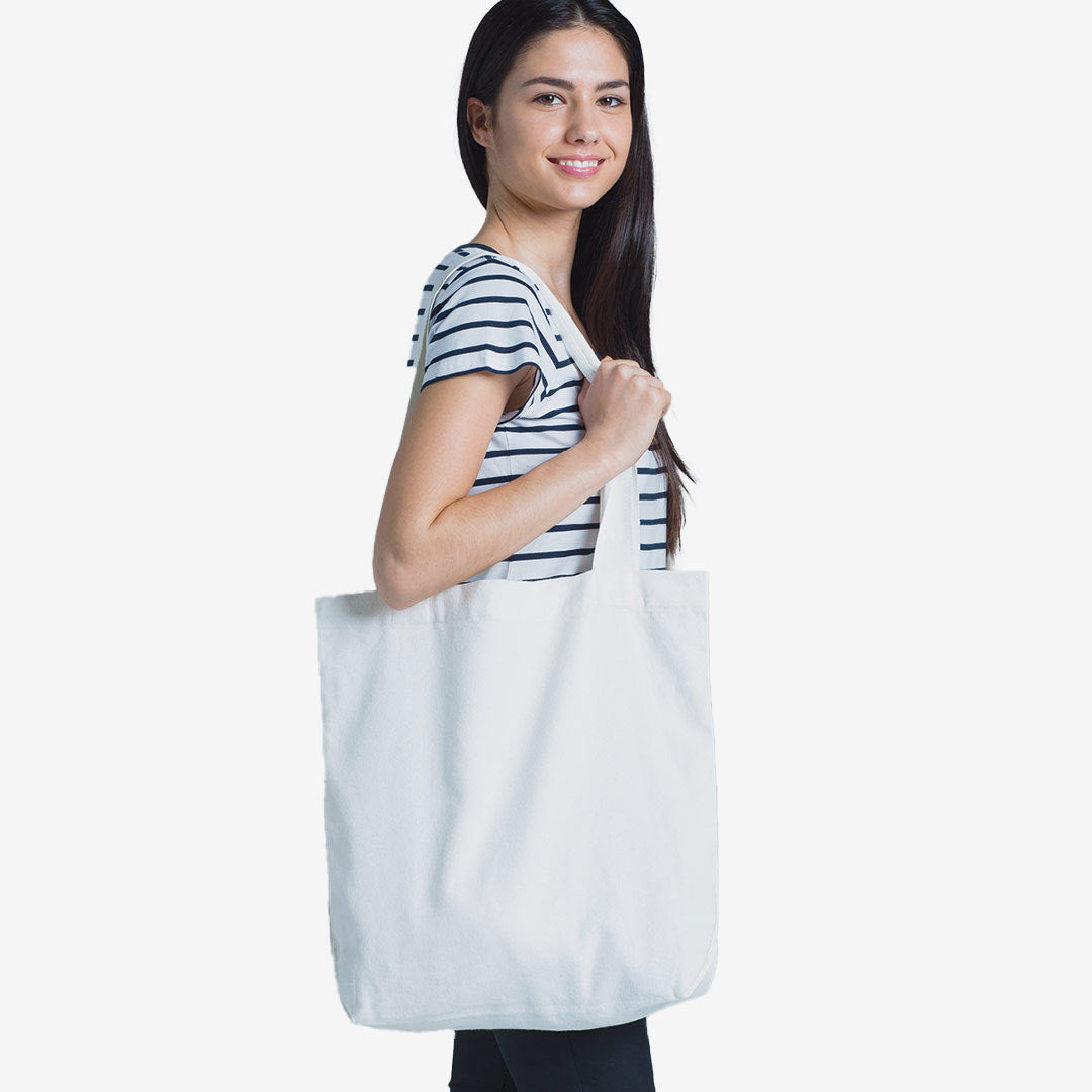Woman wearing AS Colour Carrie Tote Bag in Cream - 1001
