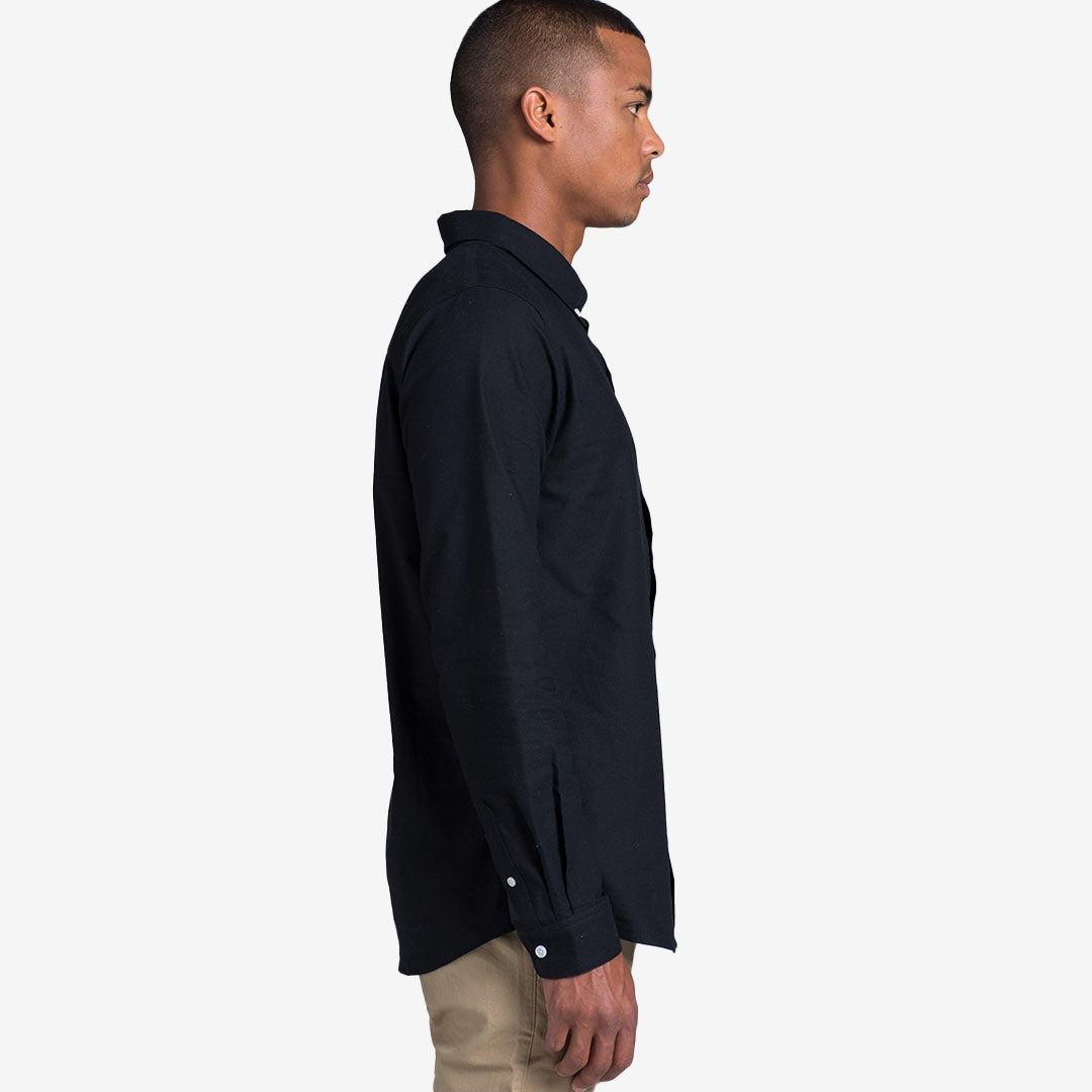 Man wearing AS Colour Men's Oxford Casual Long Sleeve Shirt in Navy Righthand Side - 5401