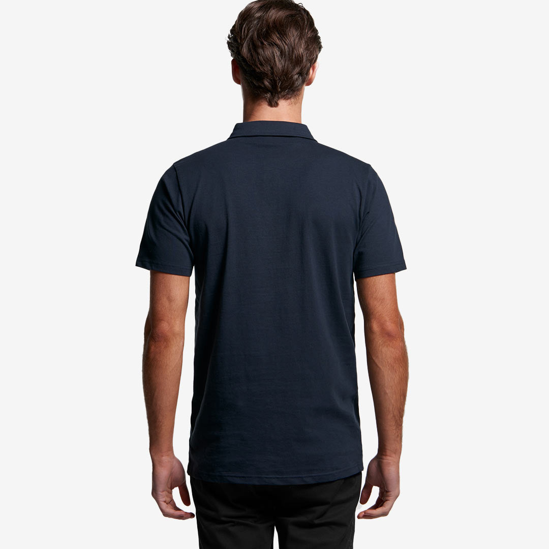 Man wearing AS Colour Men's Chad Polo in Navy Back - 5402