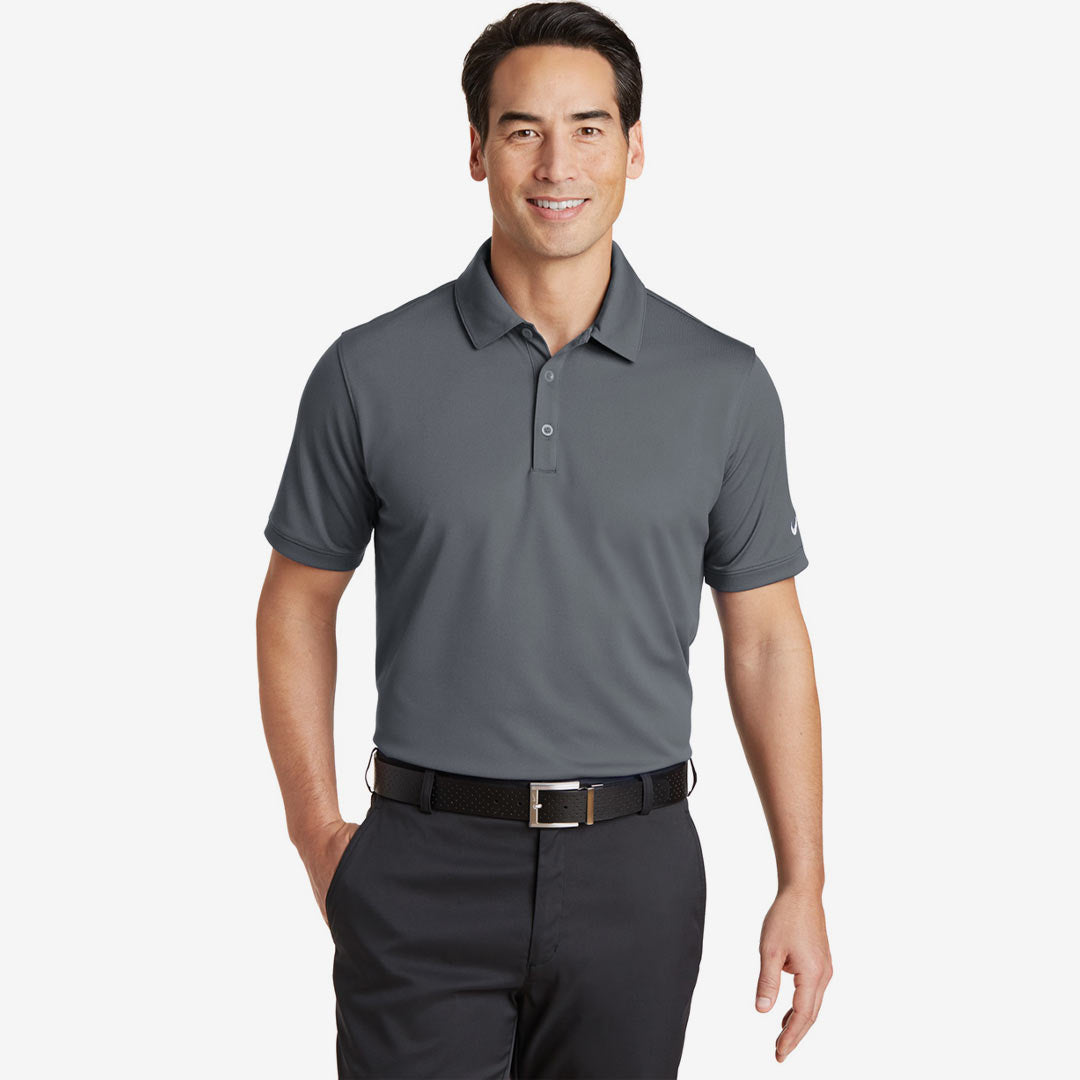Man wearing Nike Men's Dri-FIT Solid Icon Pique Modern Fit Polo in Dark Grey Front - 746099
