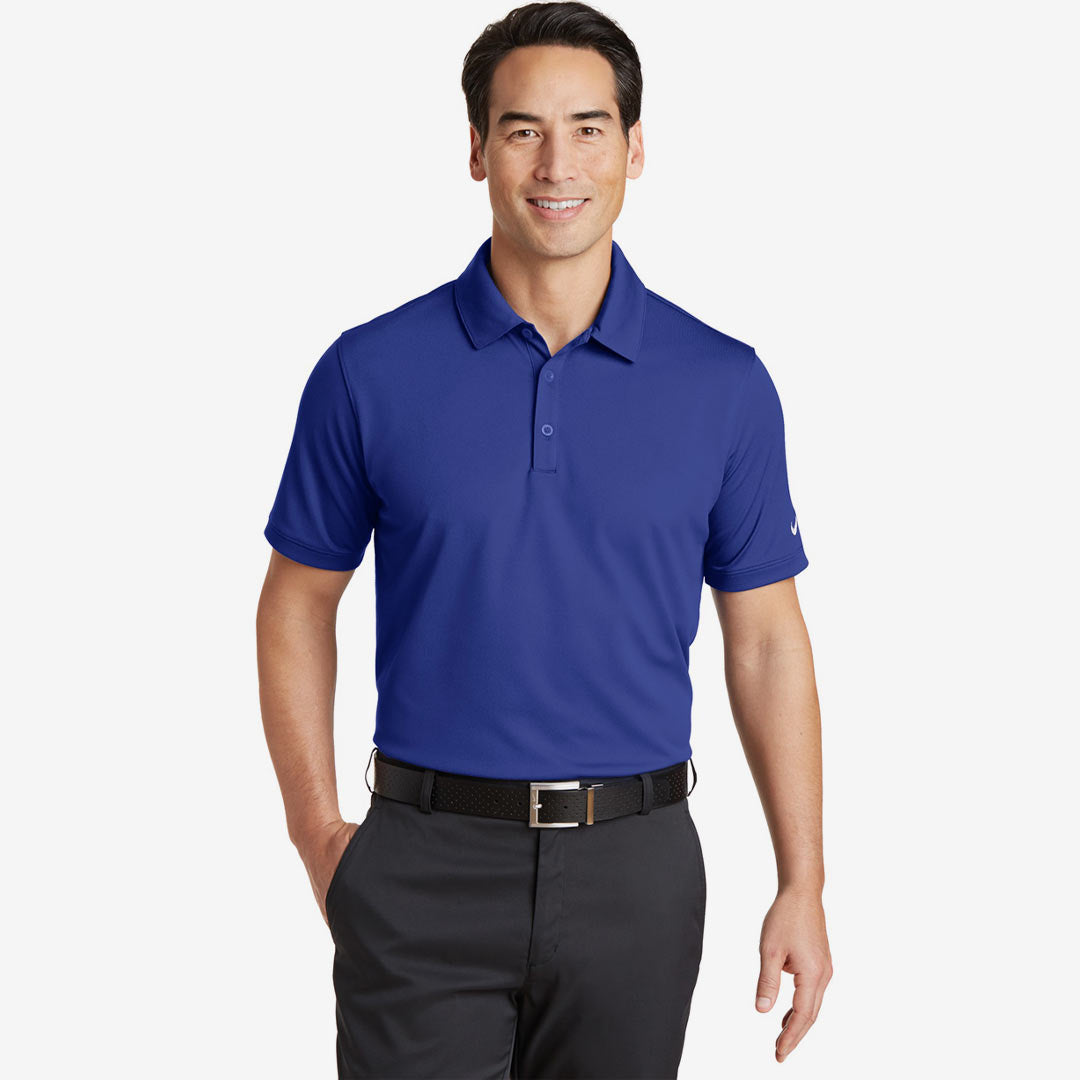 Man wearing Nike Men's Dri-FIT Solid Icon Pique Modern Fit Polo in Deep Royal Blue Front - 746099