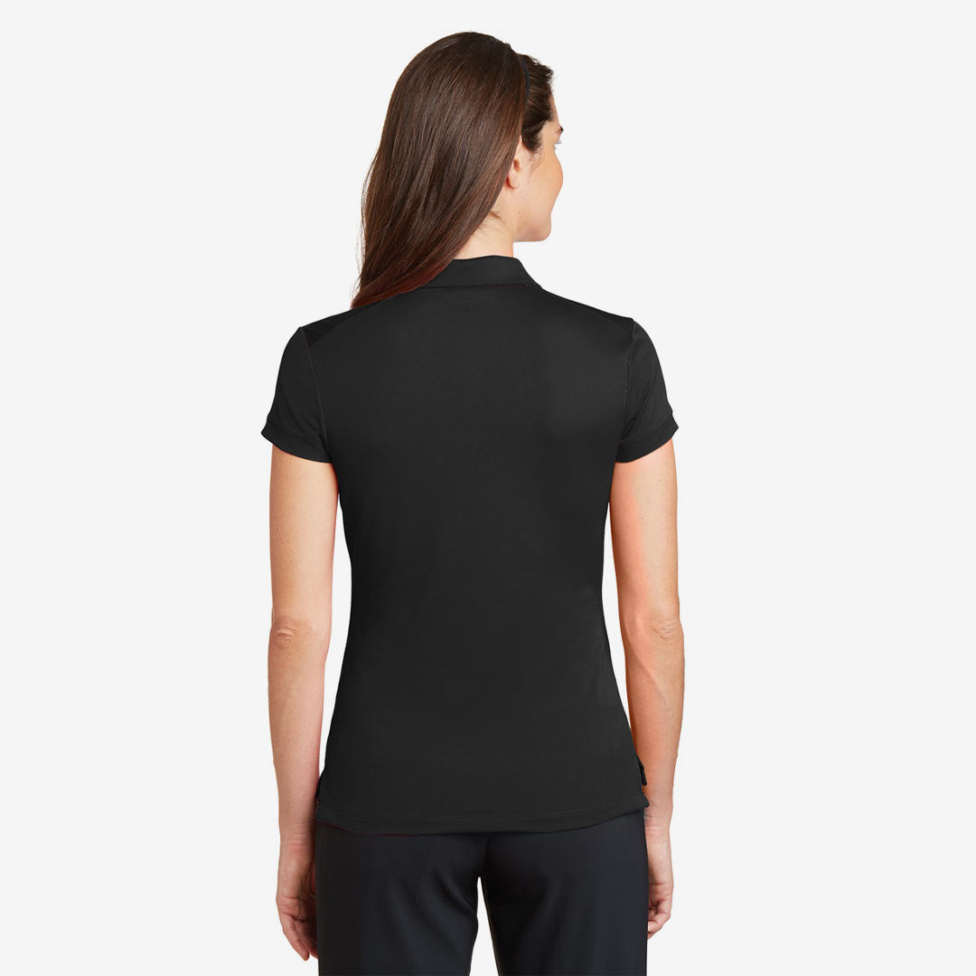 Woman wearing Nike Ladies Dri-FIT Solid Icon Pique Modern Fit Polo in Black Back - 746100