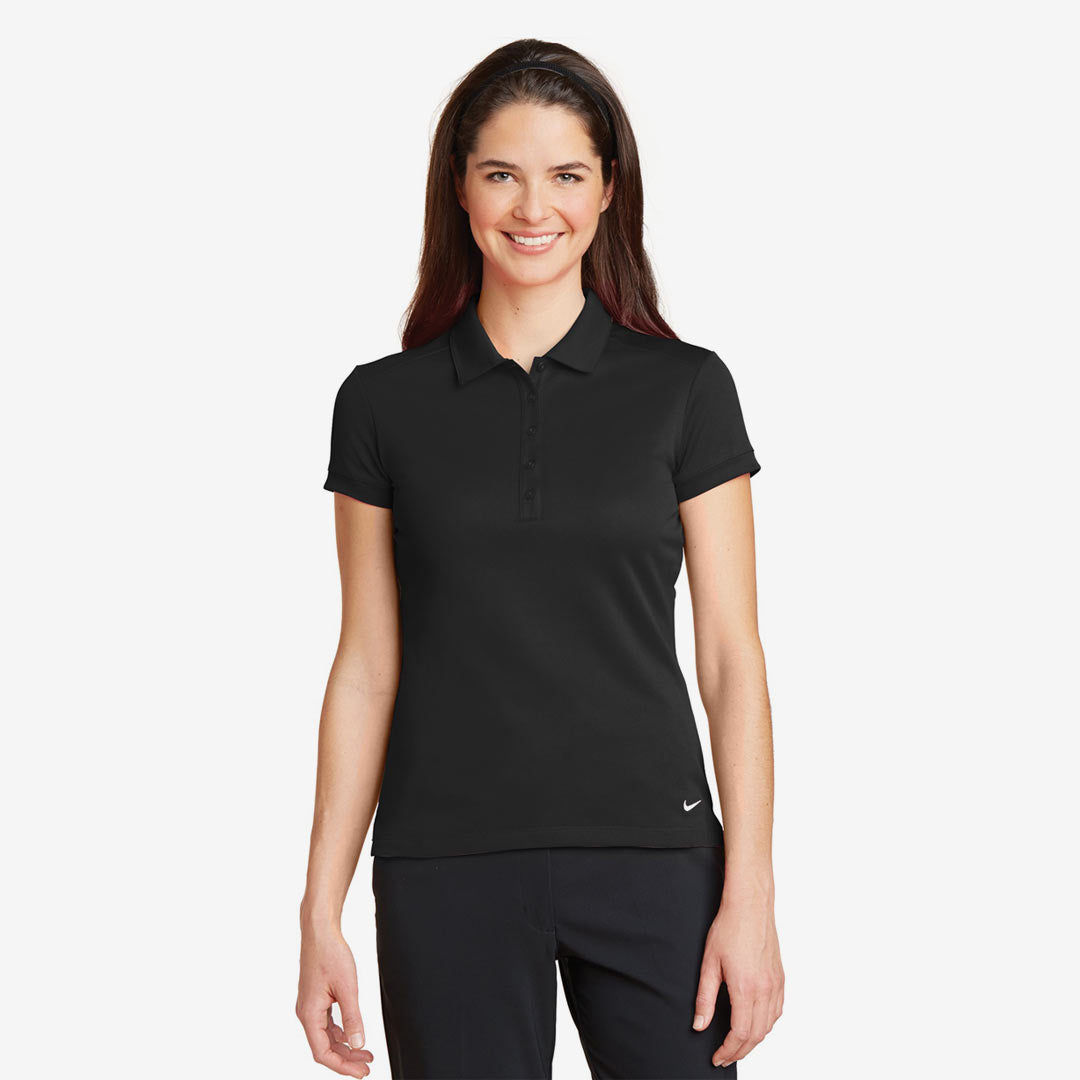 Woman wearing Nike Ladies Dri-FIT Solid Icon Pique Modern Fit Polo in Black Front - 746100