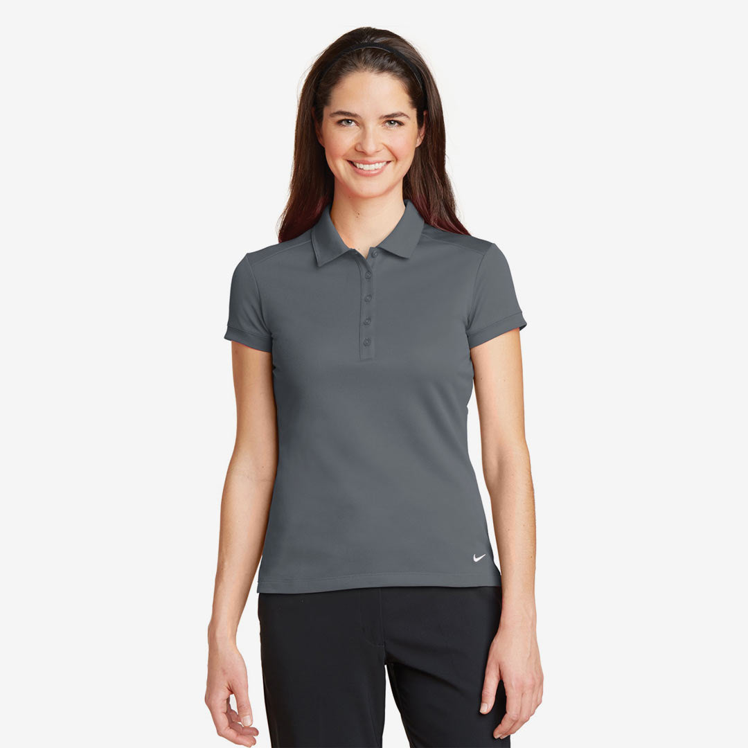 Woman wearing Nike Ladies Dri-FIT Solid Icon Pique Modern Fit Polo in Dark Grey Front - 746100