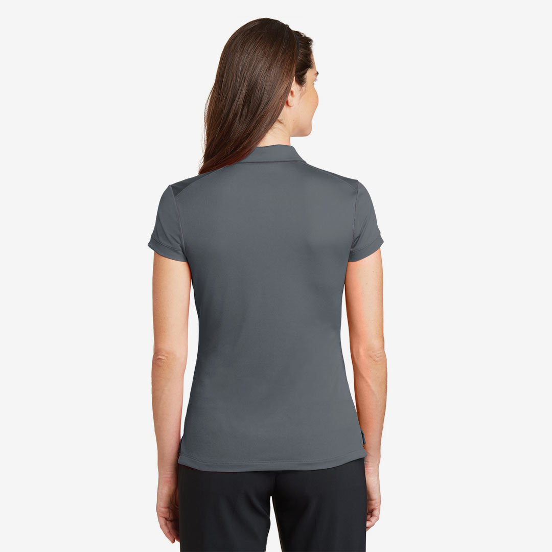 Woman wearing Nike Ladies Dri-FIT Solid Icon Pique Modern Fit Polo in Dark Grey Back - 746100