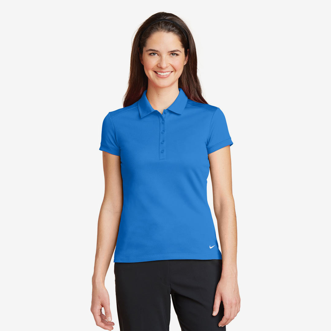 Woman wearing Nike Ladies Dri-FIT Solid Icon Pique Modern Fit Polo in Light Photo Blue Front - 746100