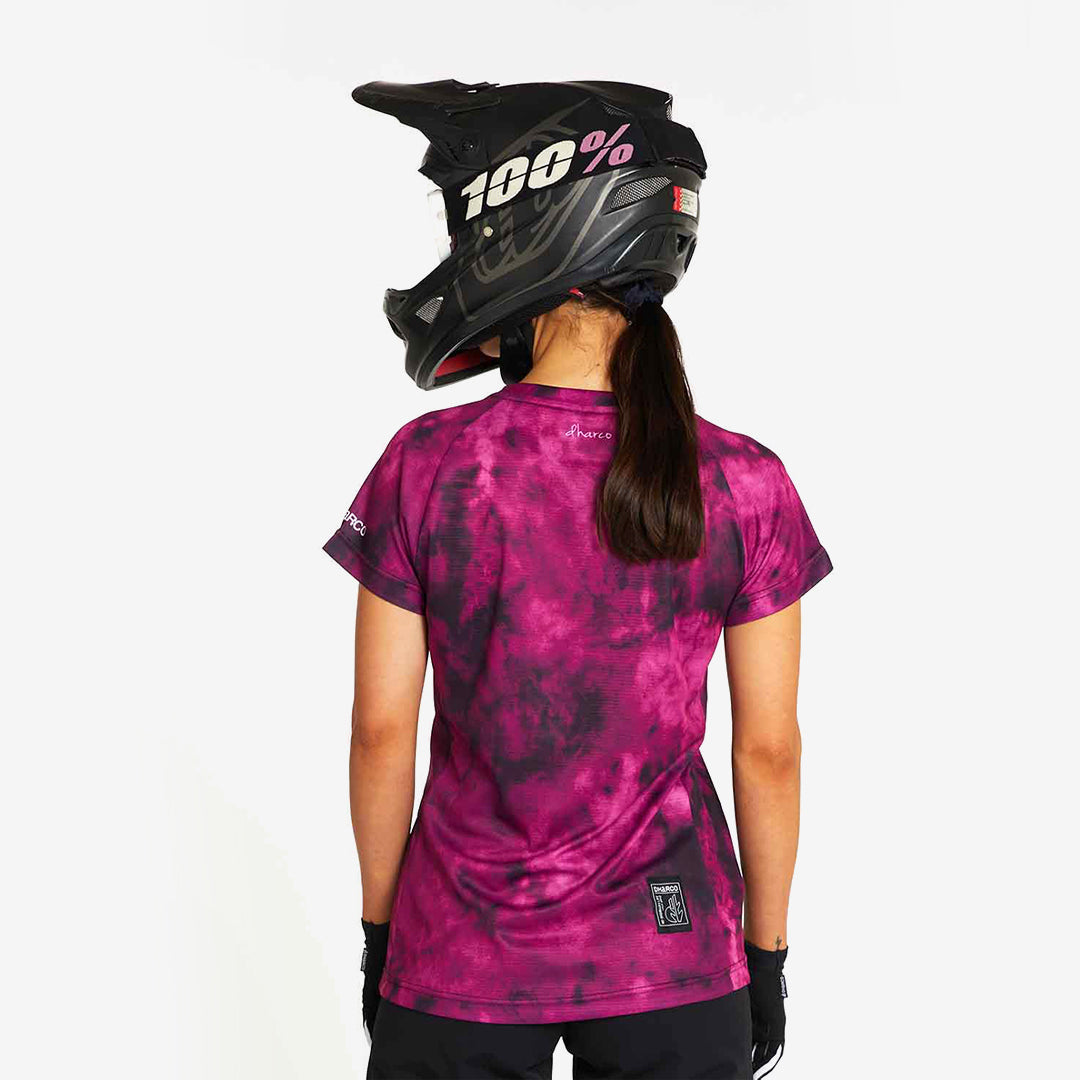Woman wearing DHaRCO Custom Branded Women's Short Sleeve Jersey in Myriam Back Angle - LSS