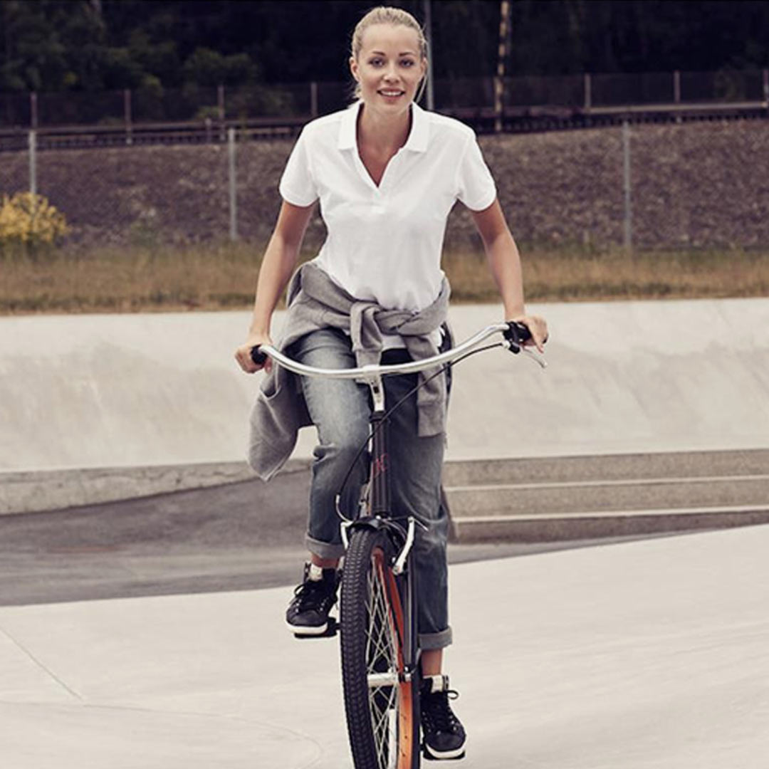Woman wearing Legend Life Surf Women's Cotton Polo in White - PA200W