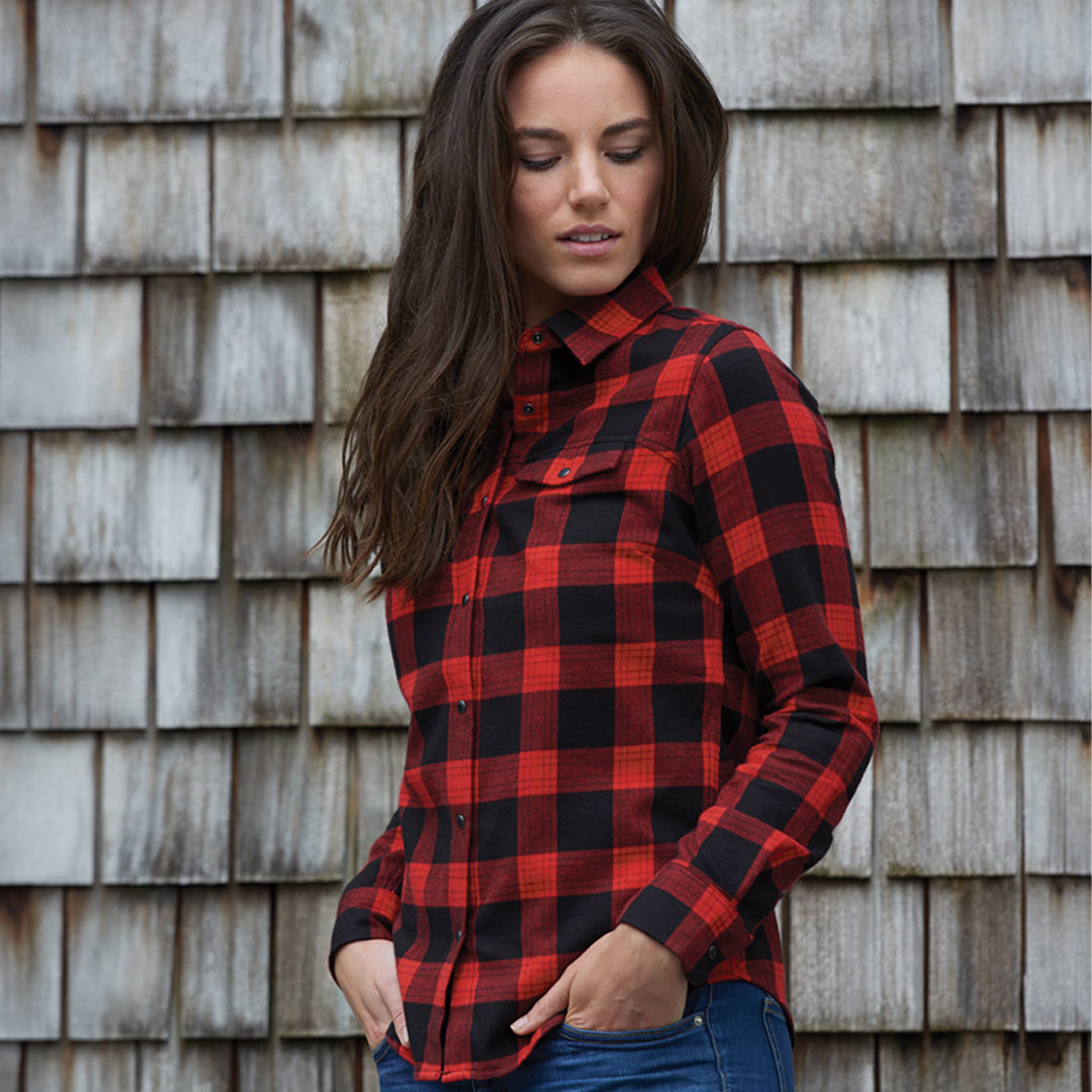 Woman wearing Stormtech Women's Logan Snap Front Flannel Shirt in Black/Red Plaid - SFX-1W