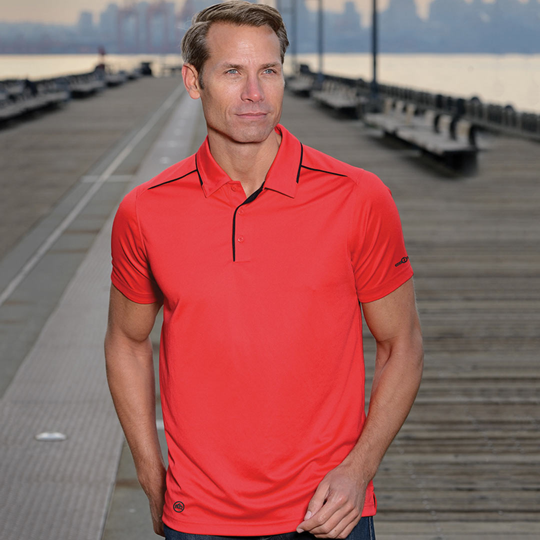 Man wearing Stormtech Men's Inertia Sport Polo in Scarlet/Red - XP-1