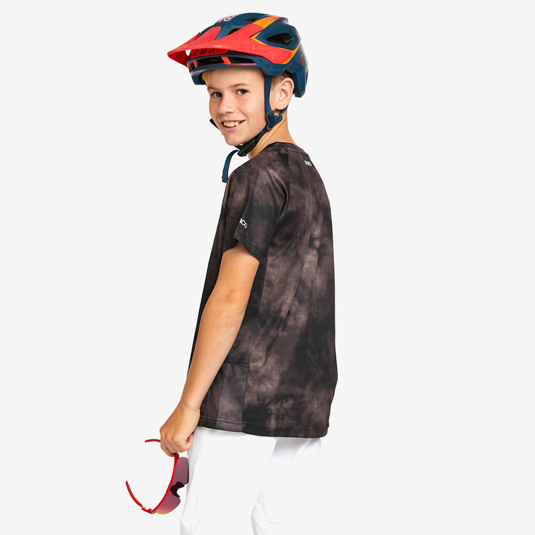 A kid wearing DHaRCO Custom Branded Youth Short Sleeve Jersey in Driftwood Back Angle -YSS