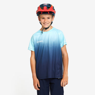 A kid wearing DHaRCO Custom Branded Youth Short Sleeve Jersey in In Deep -YSS